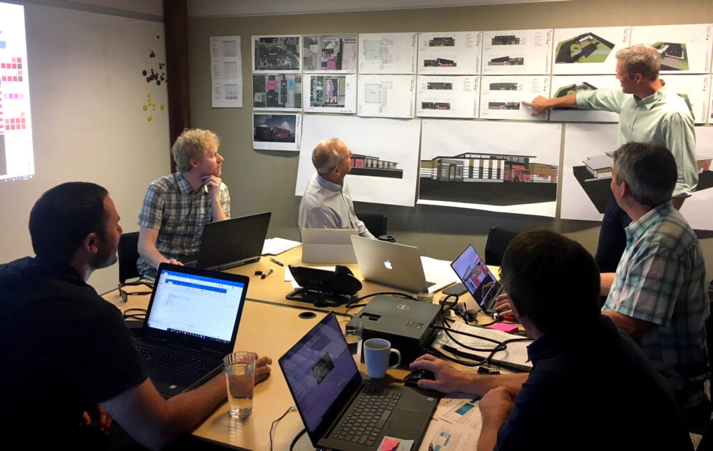 Group meeting in a conference room to discuss plans and progress of a fire district. 